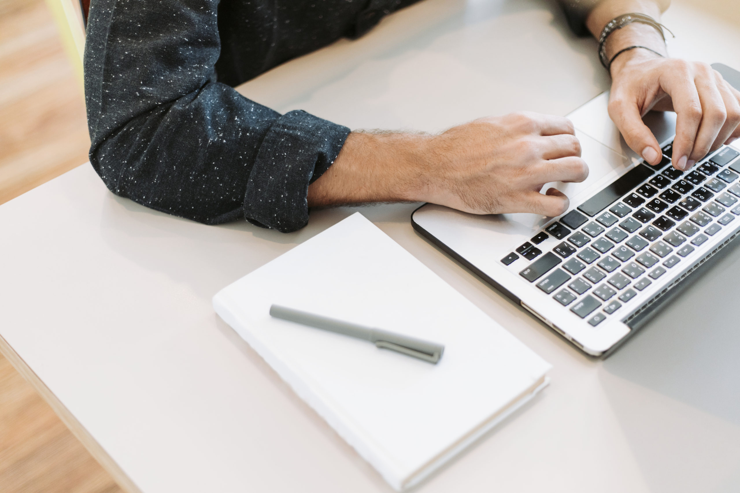 Photo of man typing at a laptop computer